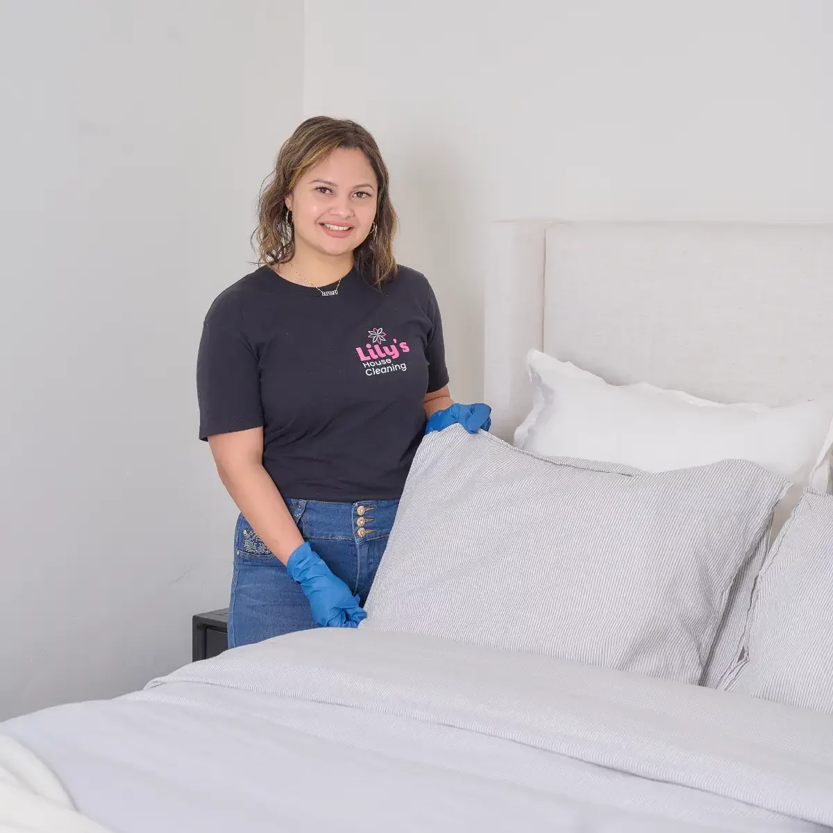 Lily's House Cleaner making the bed