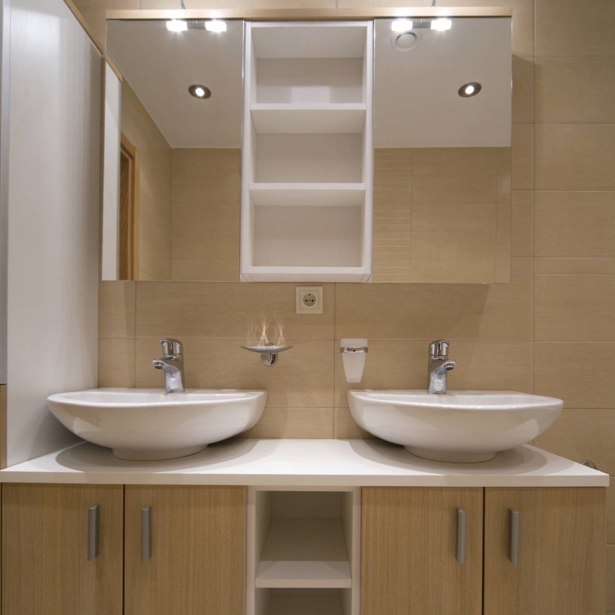 Double vanity with white sinks against tan walls