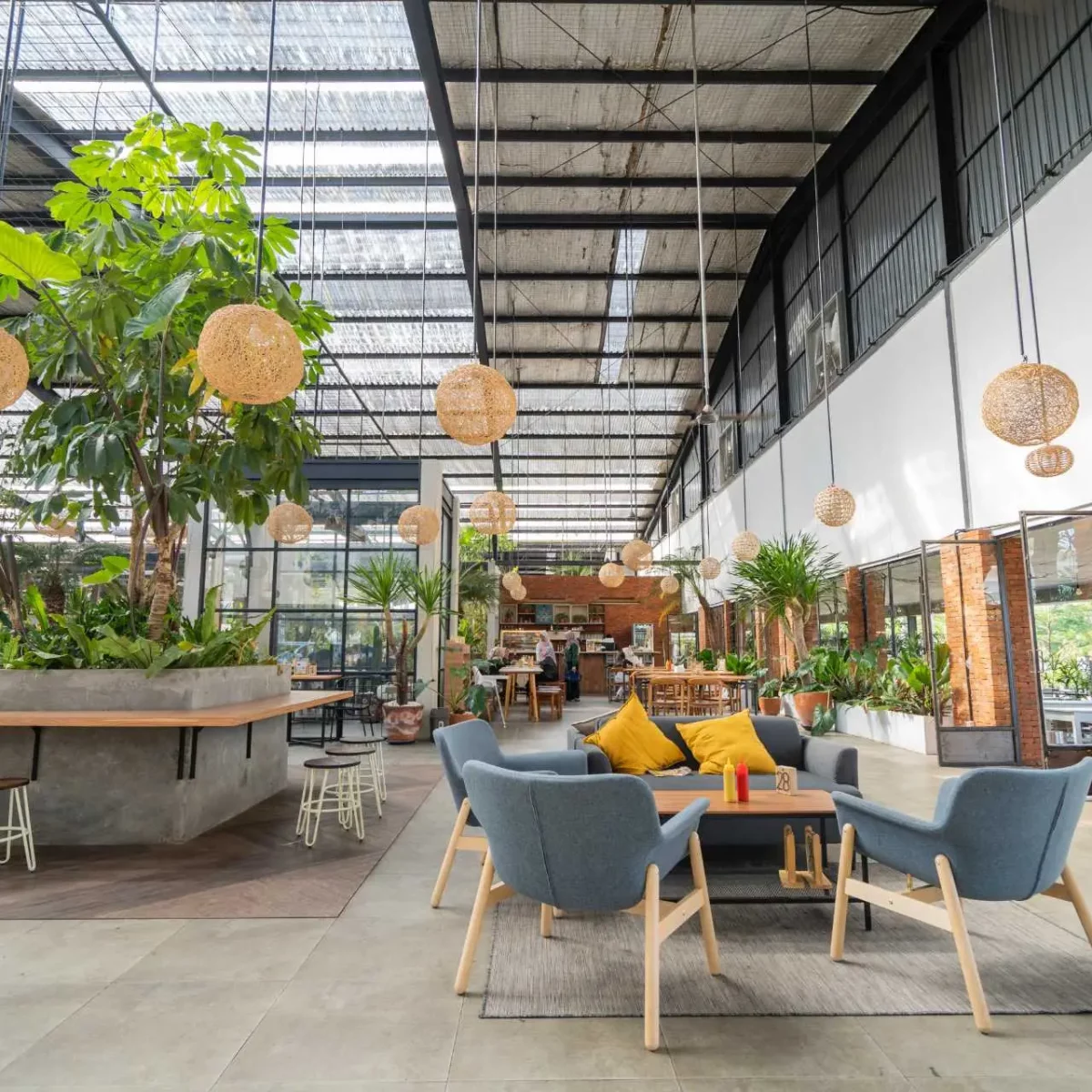 Open office space with lots of green plants and tables