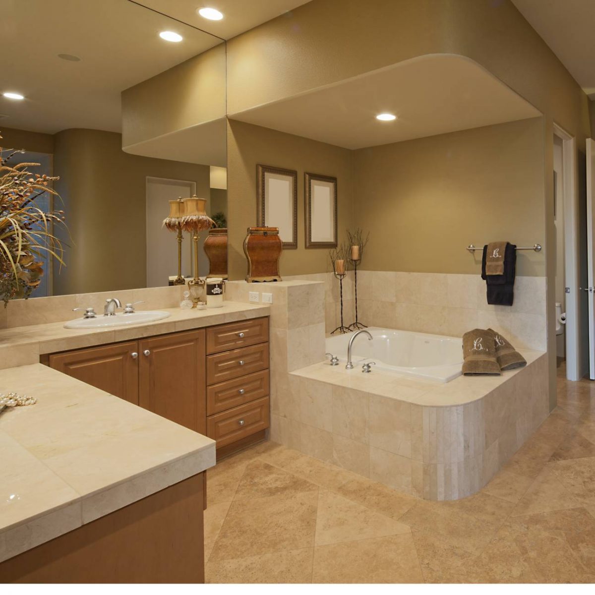 Modern tan bathroom with wrap around sink and jacuzzi